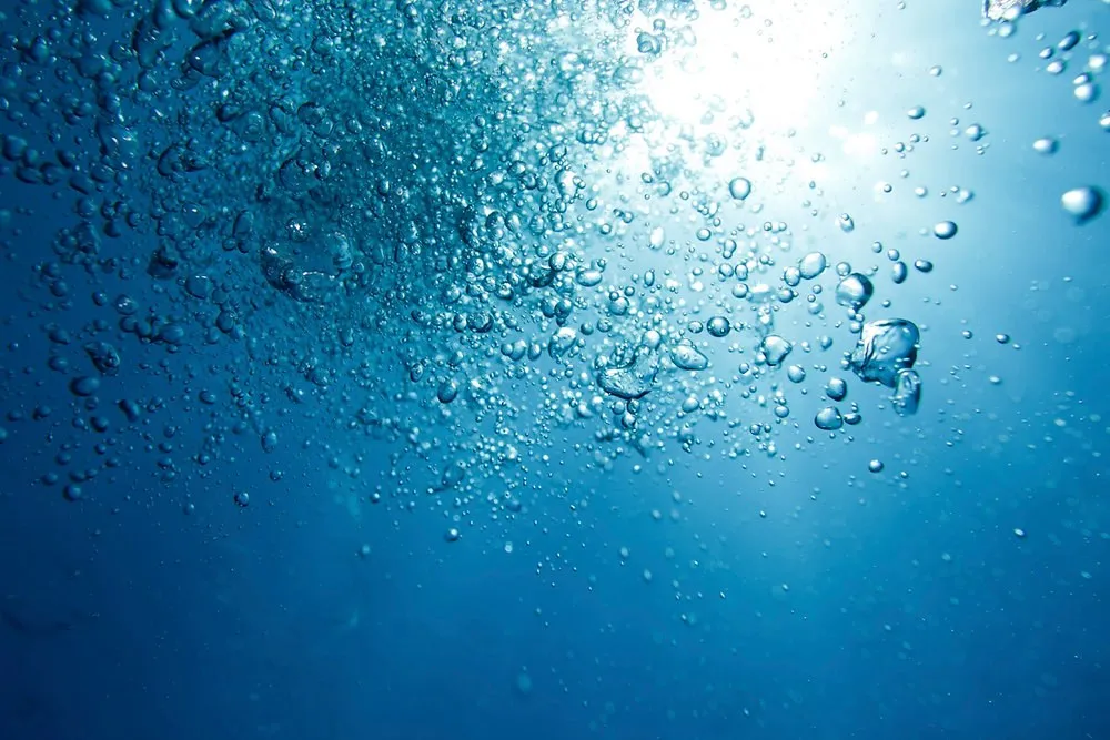 Bubbles rising through blue water